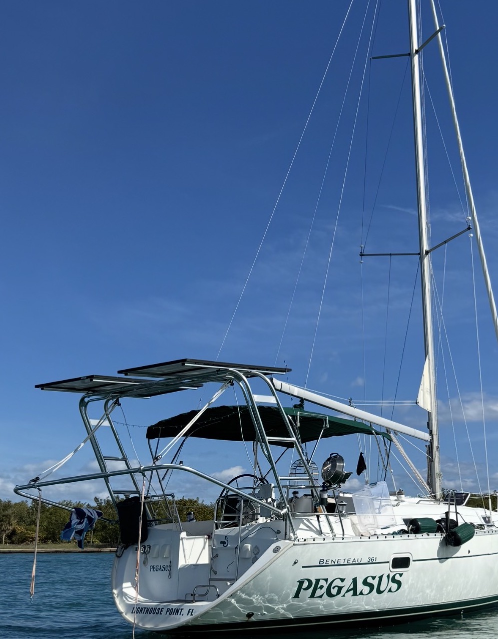 Beneteau 361 Sail Arch supporting solar panels and a tender